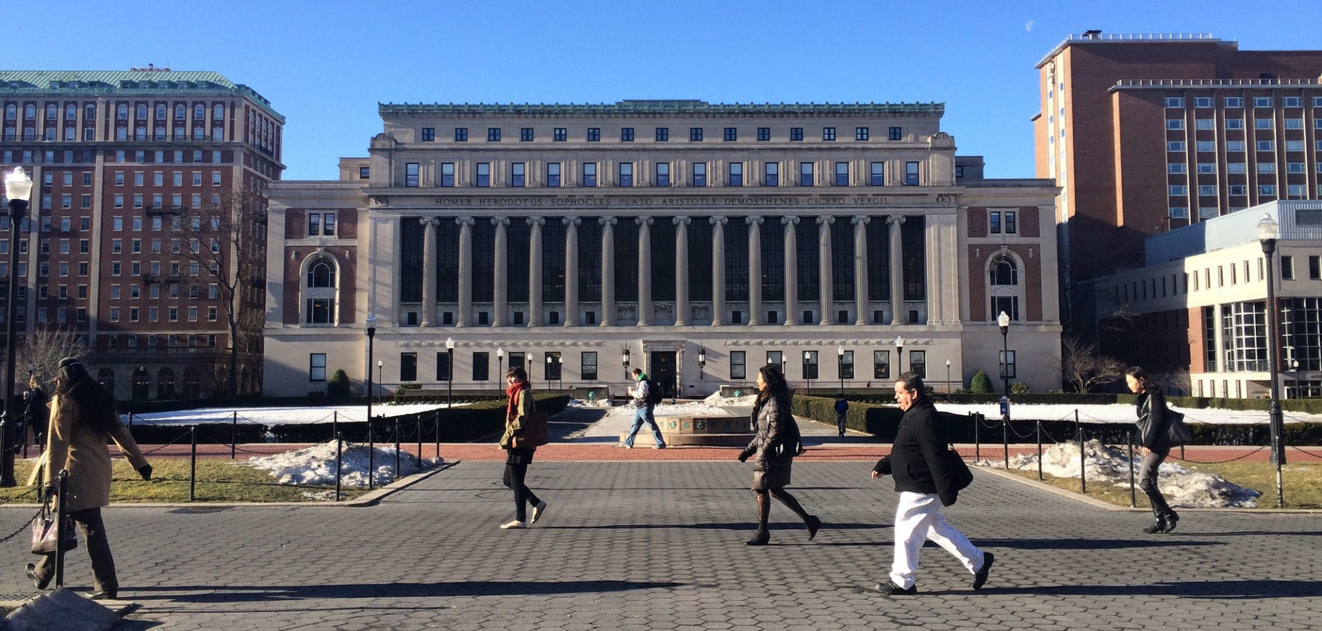 People walking past Butler library.