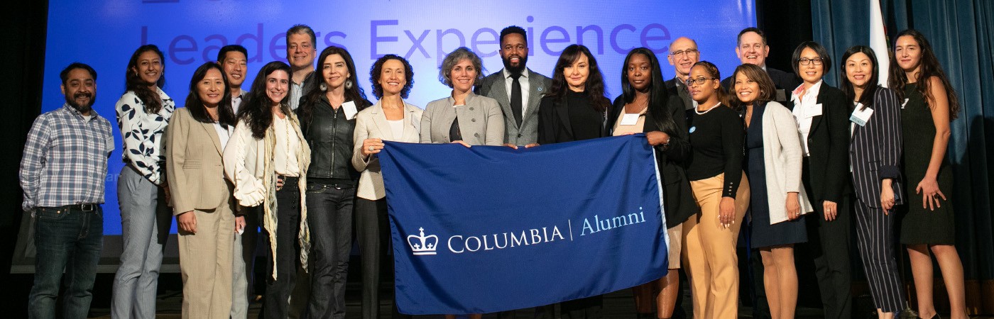 Club leaders holding Columbia Alumni banner