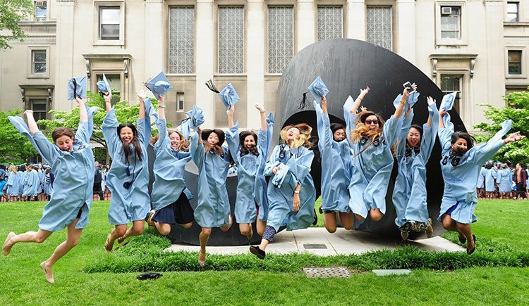 Graduates jumping in the air in front of the Curl