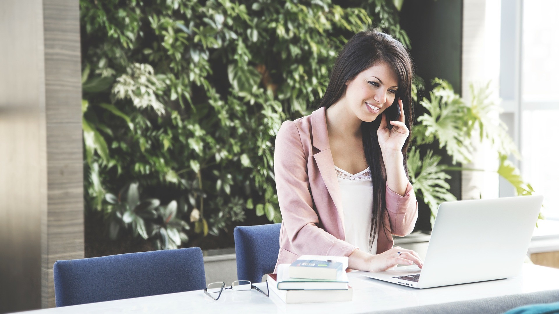 Woman on the phone and using a laptop