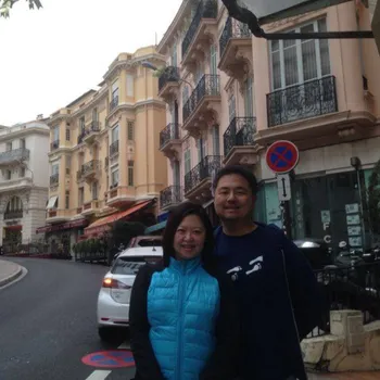 Male and female couple standing on a curved street.
