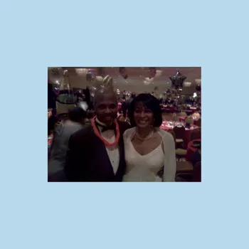 Man and women standing celebrating at a party.