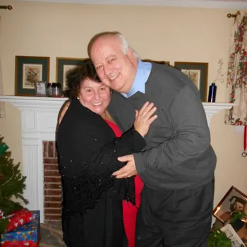 Couple hugging in their home.
