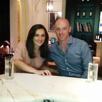 Male and female couple sitting at a restaurant table.