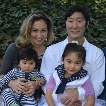 Male and female couple holding two toddlers on their laps.