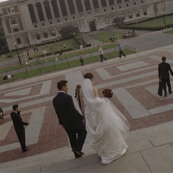 Bride and groom walking down the steps of Low Library