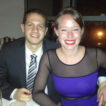 Young couple lightly and joyfully smiling dressed up at a dinner.