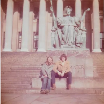 Couple sitting under ALMA and holding hands.