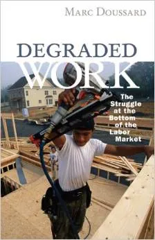 Degraded Work book cover with man in a white t-shirt working outdoors to build a wooden structure with power tools.