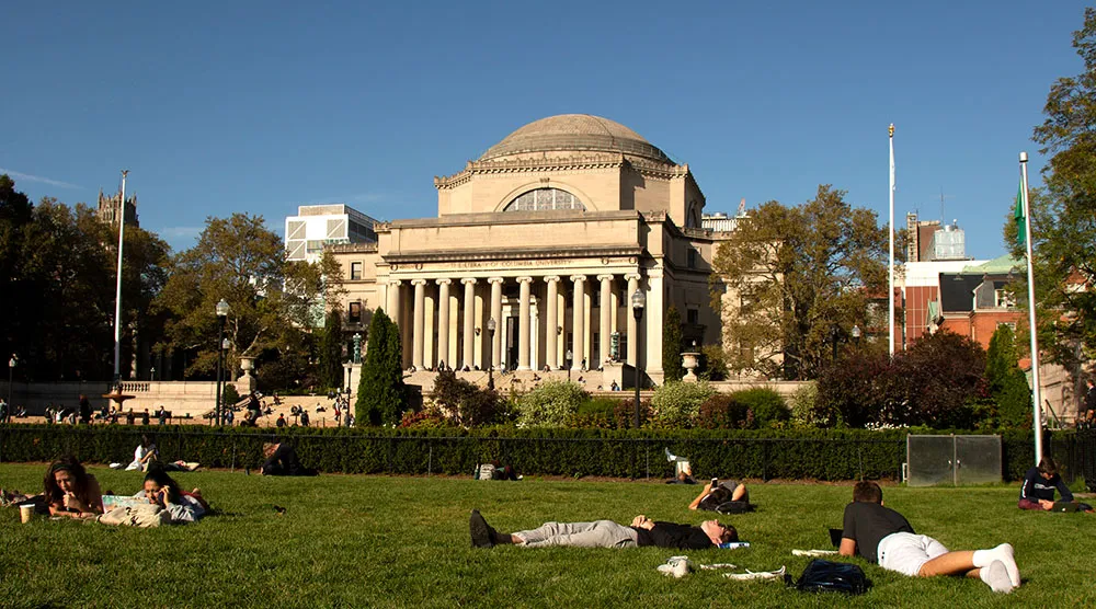Image of Low library on a sunny day with students lying on the lawn.