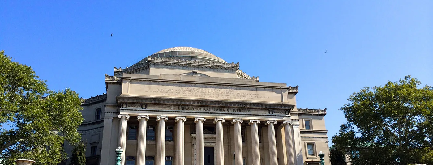 Low Memorial Library at Columbia University with columns and a domed roof against a clear blue sky.
