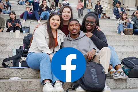 Students sitting together on campus steps, smiling, with a Facebook logo overlay.