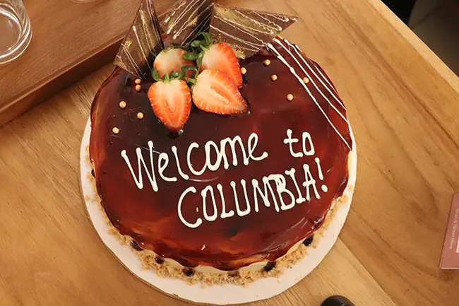 Chocolate cake with frosting text that says "Welcome to Columbia"