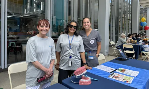 Dental Medicine volunteers with a set of demonstration teeth and brush