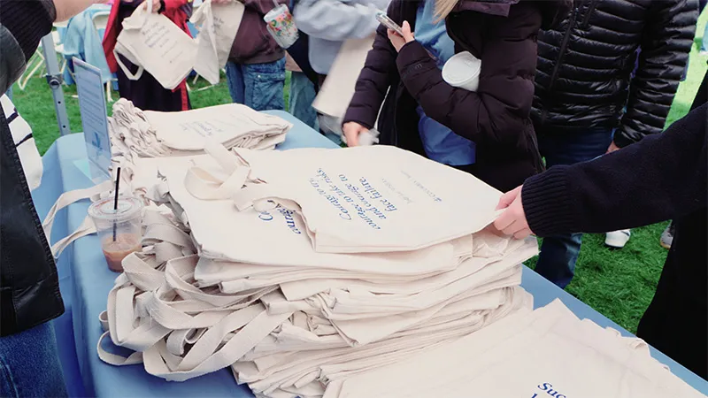 Students taking bags off the pile. 